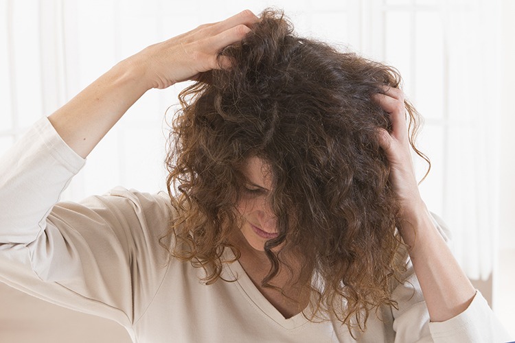 personne qui se gratte les cheveux